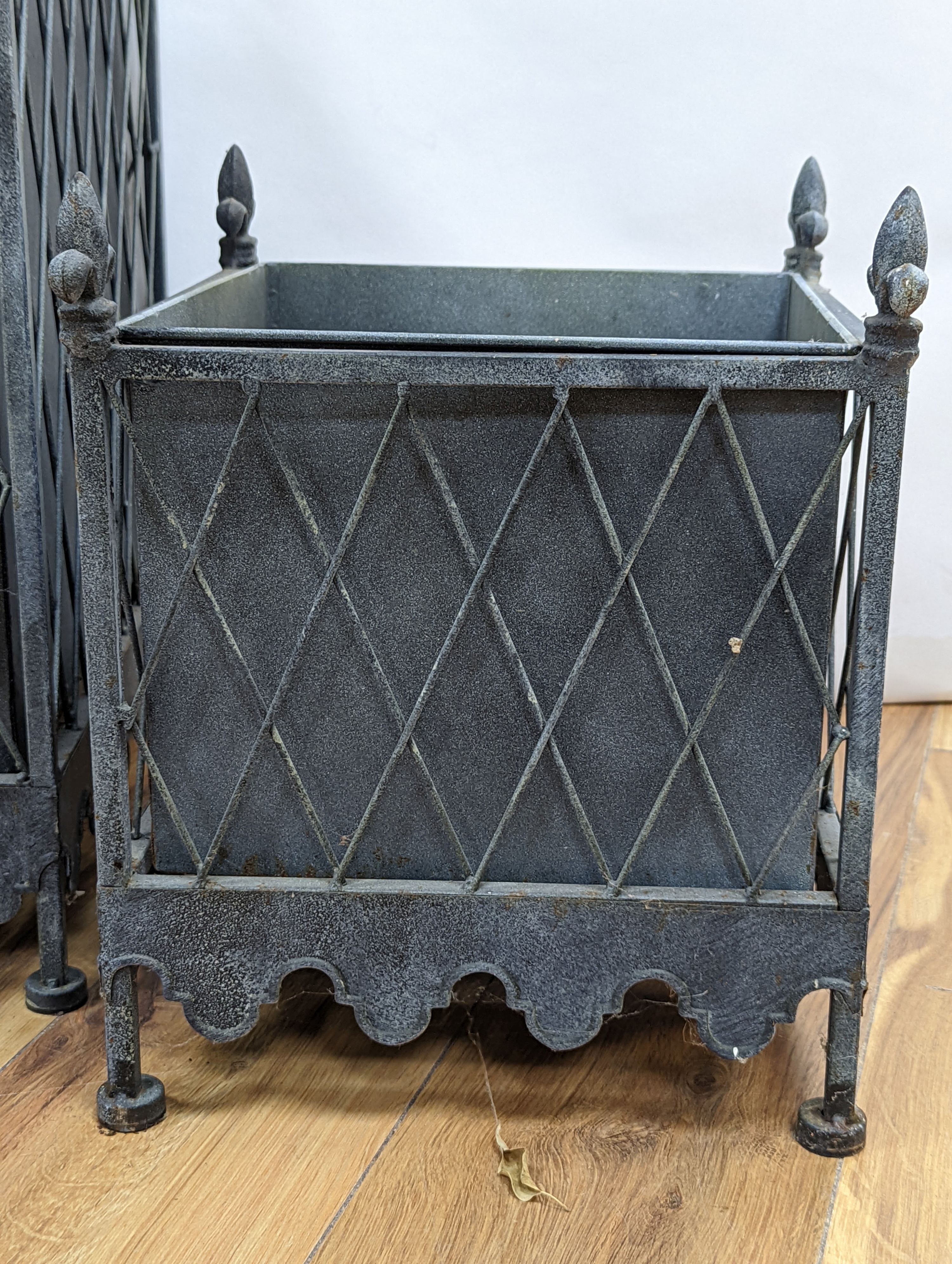 A graduated set of three zinc plated iron jardinieres, largest 41 cm wide, 51. 5 cm high